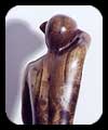Trying to Hide - walnut figurative sculpture by Christopher Rebele
